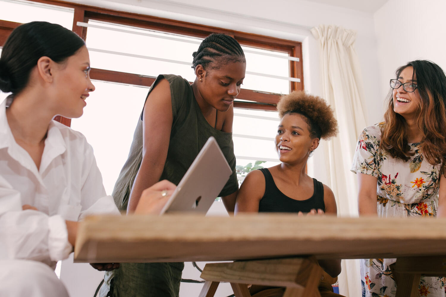 A small business team collaborating around a laptop